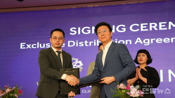 강정호 미니쉬테크놀로지 대표(오른쪽)가 계약서에 사인을 한 후 응우옌 후이 응옥 빈멕 헬스케어 시스템 부사장과 악수하고 있다.